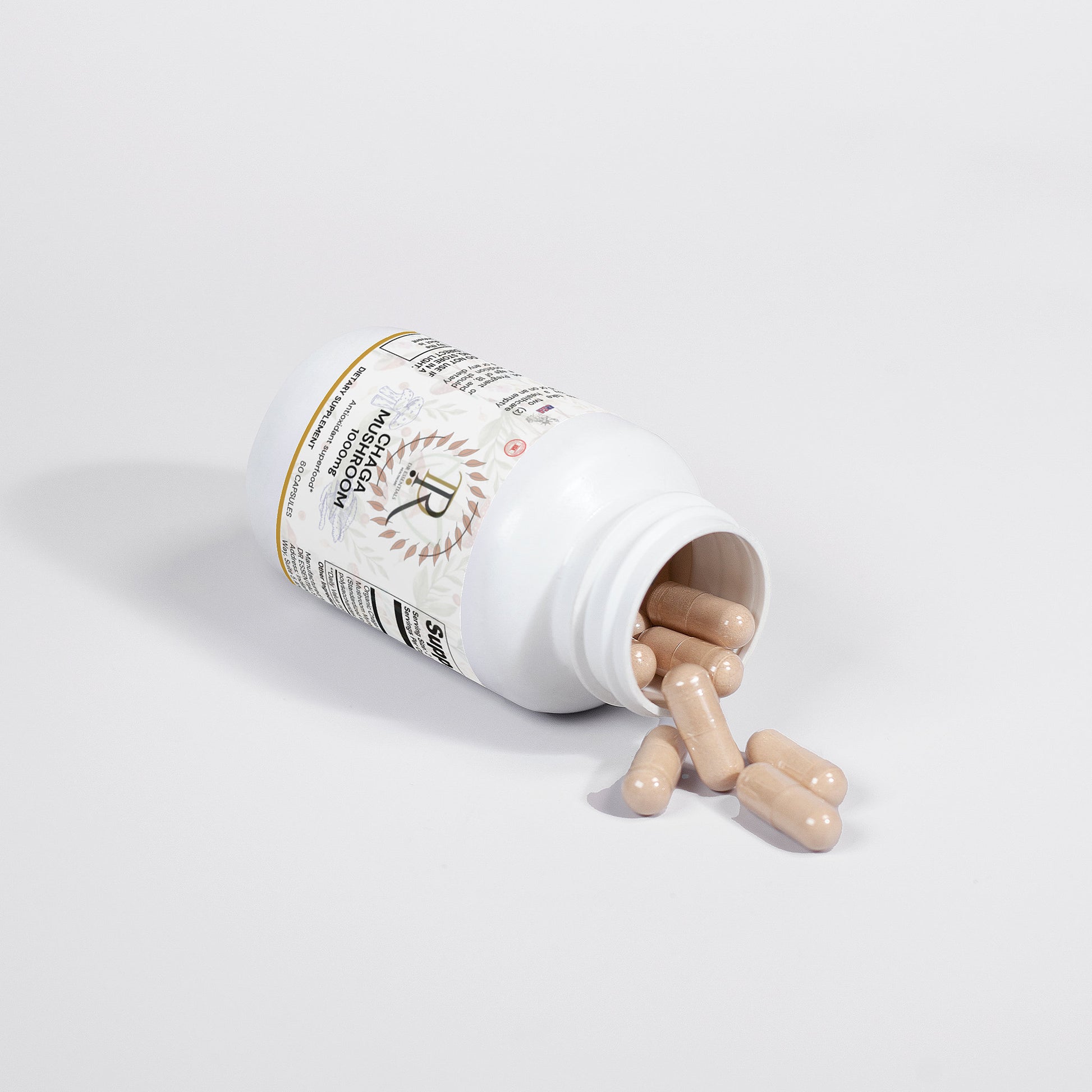 Supplement bottle with pills spilling out on a white background